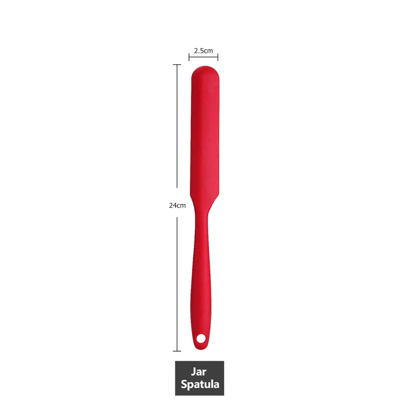 Measurement of a red silicone jar spatula, 24 cm in length with a 2.5 cm wide head.