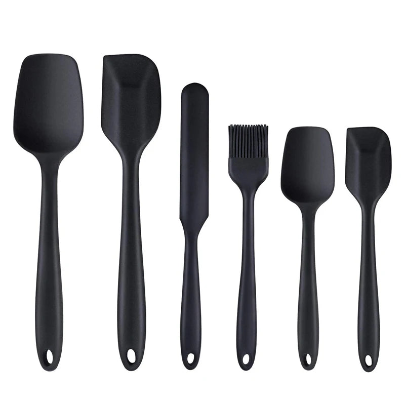 Set of six black silicone kitchen utensils, including spatulas, a brush, and a scraper, perfect for non-stick cookware and baking.