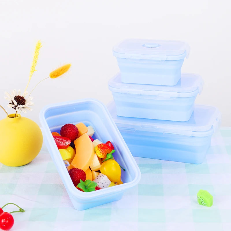 colourful collapsible silicone food storage container in  blue, ideal for saving space and keeping food fresh. showing a container with chopped fresh fruit inside.