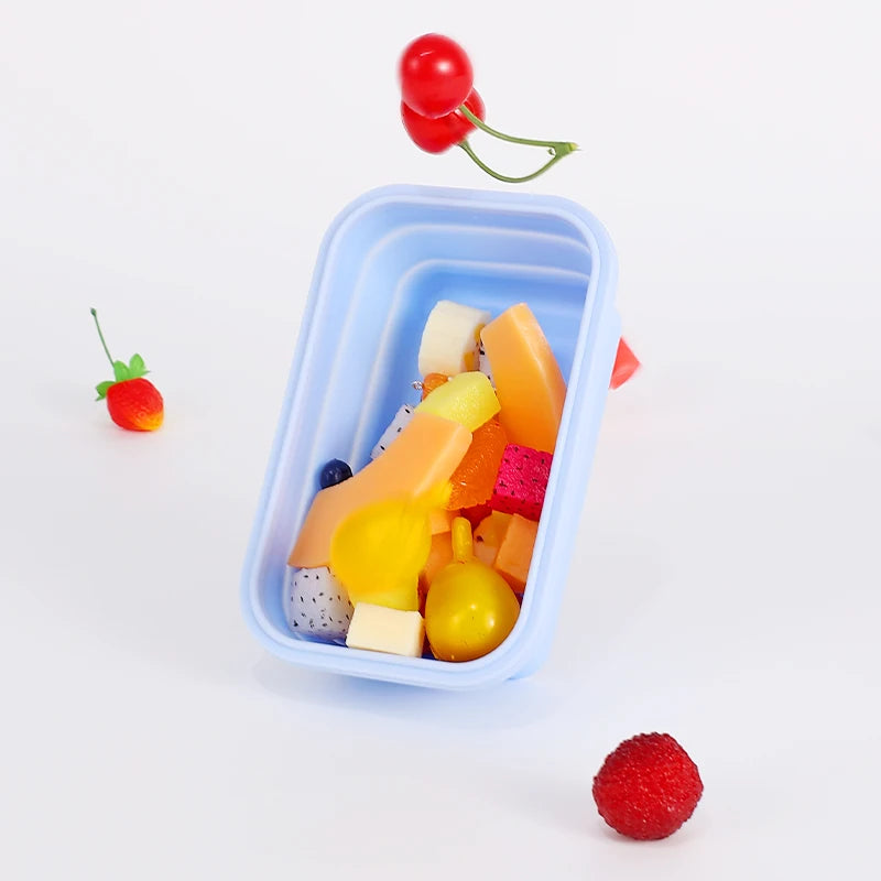 colourful collapsible silicone food storage container in  blue, ideal for saving space and keeping food fresh. showing a container with chopped fresh fruit inside.